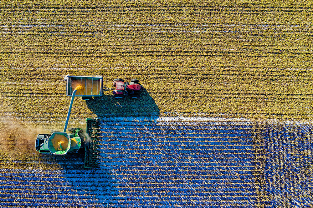 Aerial shot of tractor plowing field
