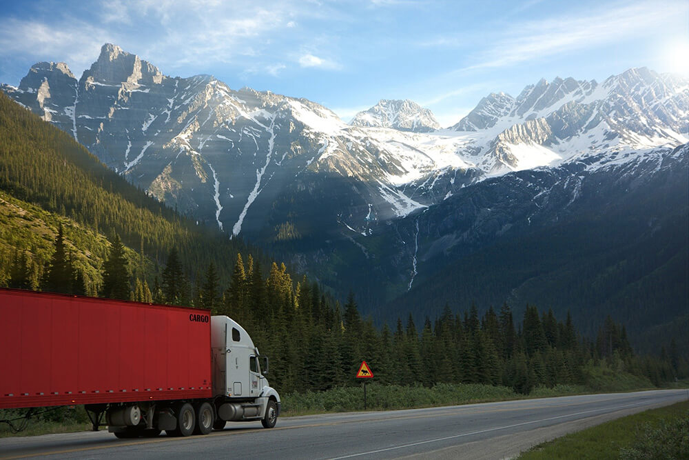Truck driving toward mountains