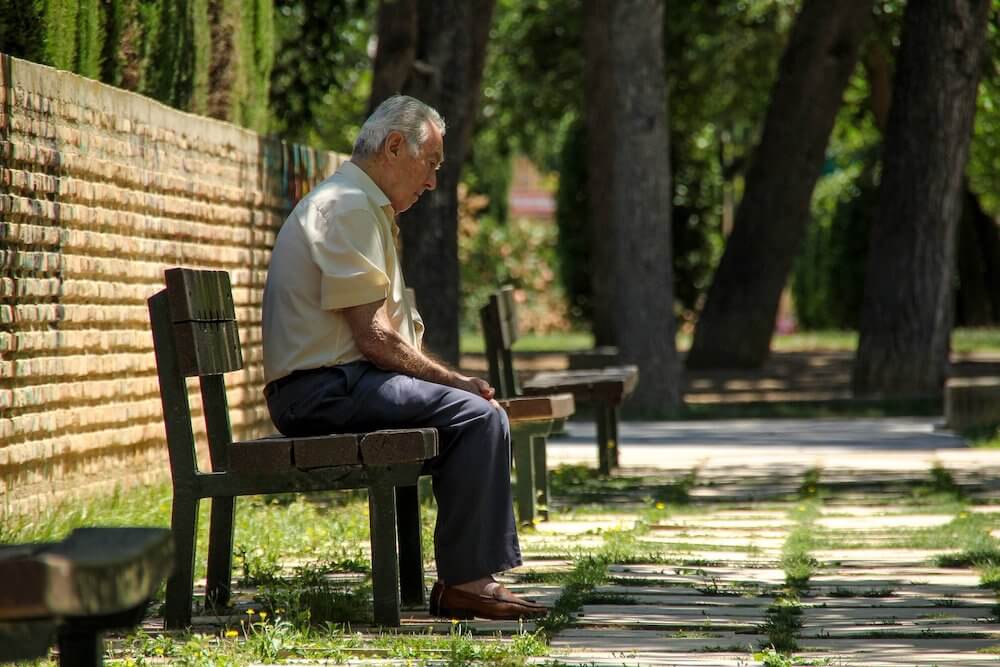 Elderly person on bench